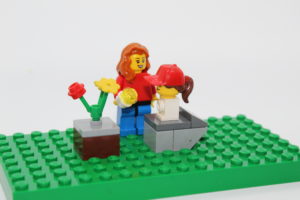 Lego scene of a mother feeding her daughter.